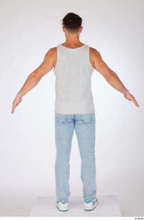 Darren a-poses blue jeans casual dressed grey tank top standing…